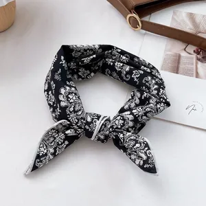 Floral paisley cotton square scarf in black and white shown with luxury styling props