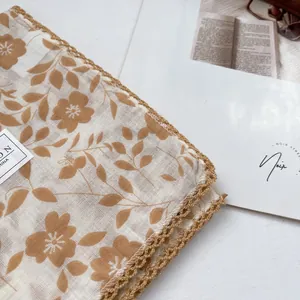 Detail of floral cotton square scarf featuring elegant crochet lace trim and vintage print