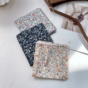 Three-piece set of floral cotton silk scarves in navy, white, and orange floral patterns