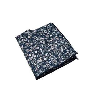 Floral print long silk scarf for hair and neck shown folded on a white background