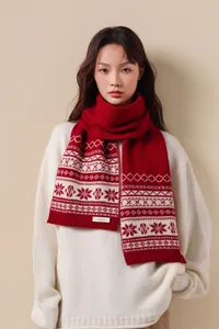 Detail of red and white Fair Isle knit scarf with 100% wool label and snowflake patterns