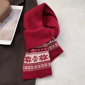 Close-up of wine red Fair Isle wool knit scarf with snowflake patterns and thick texture