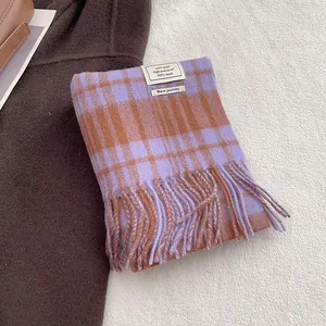 Detail of 100% wool scarf showing purple and brown checkered pattern and fringe edges