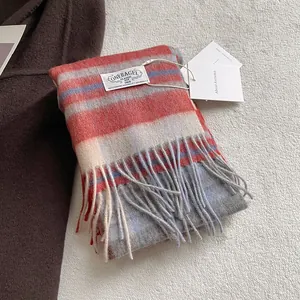 Classic orange and blue plaid 100% wool scarf with tassels on a soft white background