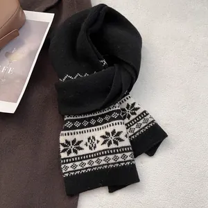 Detail of Fair Isle wool scarf with black and white snowflake patterns on a coat