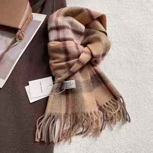Close-up of vintage brown check wool scarf with fringe details and woven brand label