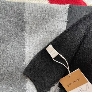 Thick wool blend knitted scarf featuring a tri-color block design in black and grey