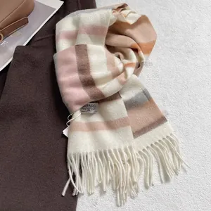 Detailed texture of blue striped wool scarf with long tassels and premium brand label