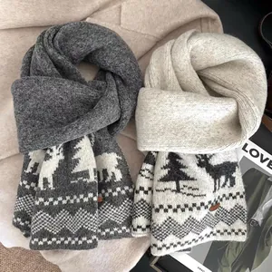 Close-up of reindeer pattern and leather label on winter knitted wool scarves
