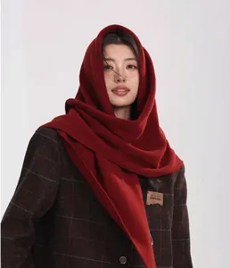 Detailed knit texture of a dark red 100% wool triangle scarf and neck warmer for winter