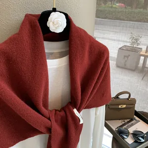 Detail shot of the 100% pure wool red knitted shawl showing premium weaving texture