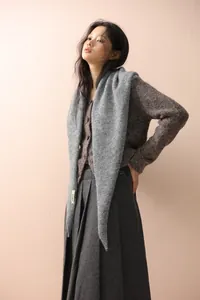 Close-up of soft grey knitted triangle shawl showing fluffy mohair texture and premium weave