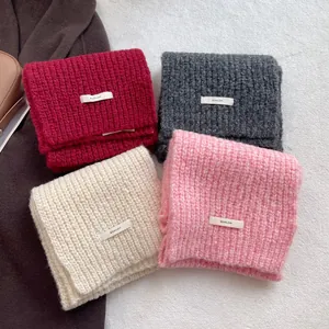 Thick wool knit scarf for women in assorted colors with minimalist brand tag