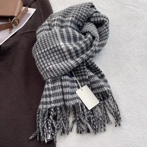 Close-up of classic houndstooth scarf with soft fringe and premium wool texture