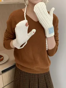 Close-up of knit gloves with neck strap and touch screen finger opening for women