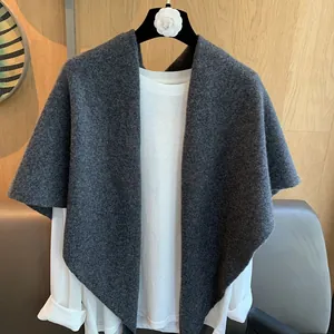 Dark grey 100% wool knit triangle scarf shawl elegantly draped on a hanger