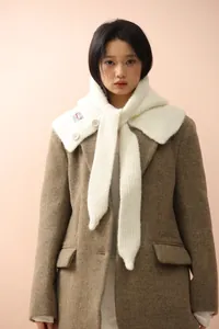 Detailed texture of a cream knit balaclava scarf with white buttons on a brown wool coat