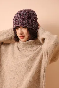 Detailed close-up of handmade honeycomb wool knit texture on a cozy winter hat