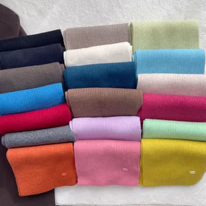 Detailed macro view showing the soft ribbed texture and diverse colors of the wool scarf