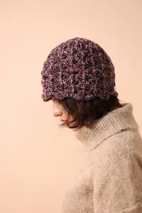 Detail of multi-color wool knit fisherman hat featuring textured hollow-out crochet pattern
