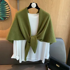 Detail of green 100% wool knit shawl tied over white shirt for autumn winter styling
