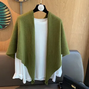Detail shot of grass green knitted wool shawl showing delicate texture and weave