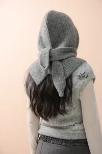Close-up of soft grey balaclava and Nordic jacquard vest for winter knitting texture