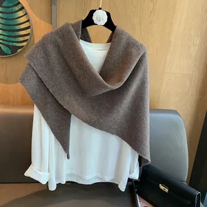 Detailed texture of dark brown 100% wool knit shawl draped over a white long sleeve shirt