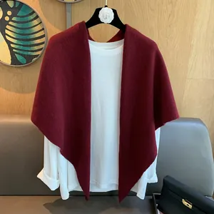 Detailed texture of burgundy 100% wool knitted triangle scarf with irregular long hem