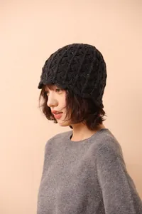 Detailed view of dark grey crochet knit beanie showing thick wool blend texture and diamond pattern
