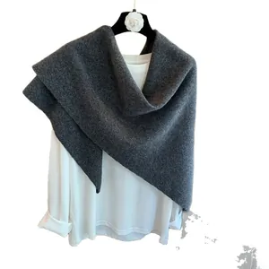 Dark grey knitted 100% wool triangle scarf and wrap styled on a white long sleeve top