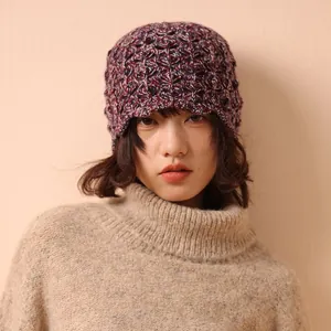 Women's 100% wool knit hat featuring colorful crochet patterns and a hollow lace design