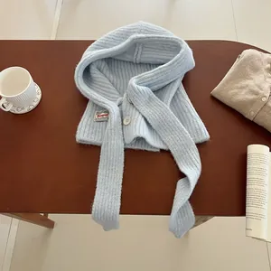 Detail of light blue knitted balaclava hood with buttons and vertical ribbing texture