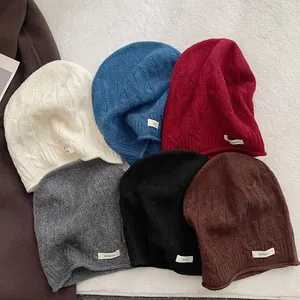 Auswahl an 100% Wollstrickmützen in sechs Farben mit warmer grober Zopfmuster-Textur