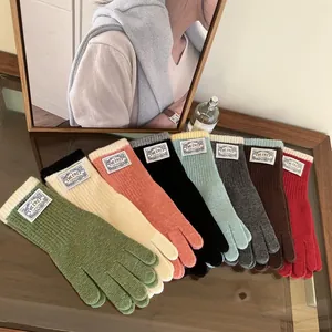 Detailed view of colorful knit gloves in eight vibrant shades with premium ribbed cuffs