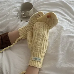 Chunky knit cream gloves with hanging string and cable pattern for winter warmth