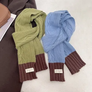 Pink and blue cable knit scarves with stylish ribbed cuffs and decorative labels
