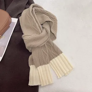 Detailed view of khaki knitted scarf featuring chunky cable knit and honeycomb texture