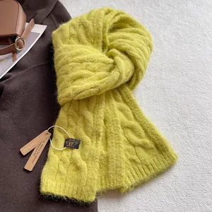 Macro view of bright yellow cable-knit wool scarf texture with soft fluffy finish