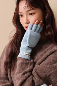 Close-up of light blue 100% wool knit convertible gloves with brand woven label