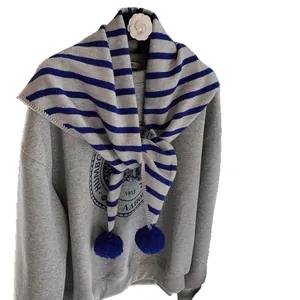 Grey retro sweatshirt with striped knit scarf featuring dark blue pom-poms for winter