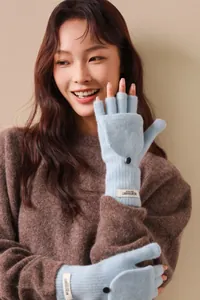 Close-up of light blue wool blend convertible flip-top gloves with black button detail