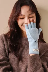 Detail showing blue wool knit gloves with convertible flip top worn by model
