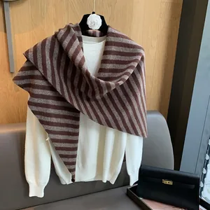 Close-up of striped pure wool knitted shawl texture and soft brown pattern detail