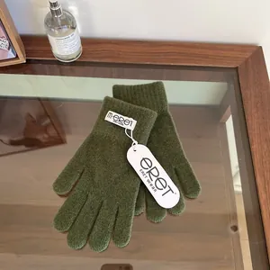 Close-up of olive green knitted gloves with m·eret woven label and original tags