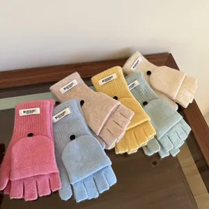 Flat lay of colorful wool blend convertible mittens with buttons in six pastel shades