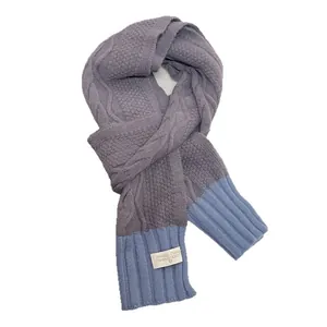 Pink knit scarf with thick cable weave and light blue ribbed ends for winter warmth