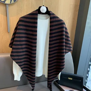 Detail of coffee and black striped wool knit shawl with fine texture and triangular tip