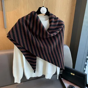 Detailed knit texture of premium striped wool shawl in brown and black pattern