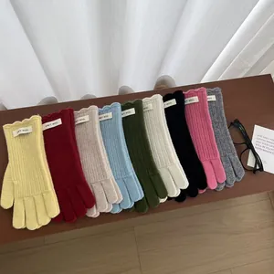 Classic thick wool knit gloves in nine colors shown on a wooden bench with touch screen design